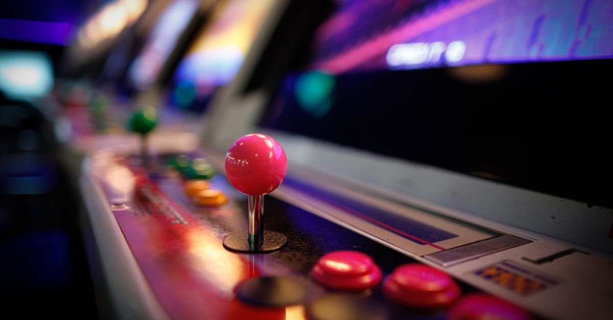 Joystick rosa e botoes de maquina de fliperama em closeup