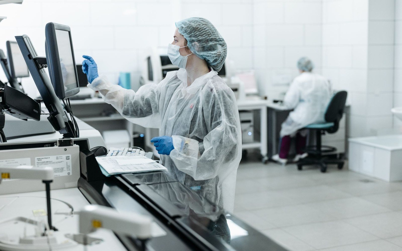 Profissional de laboratório opera equipamento de análises clínicas em sala de exames